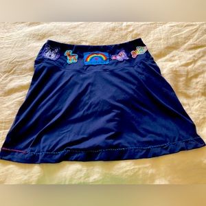 High-waisted athletic skirt with hand-sewn patches.
